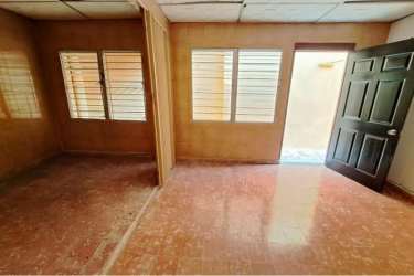 Exterior view with metal gate, driveway, tiled roof house for sale La Chorrera Panama