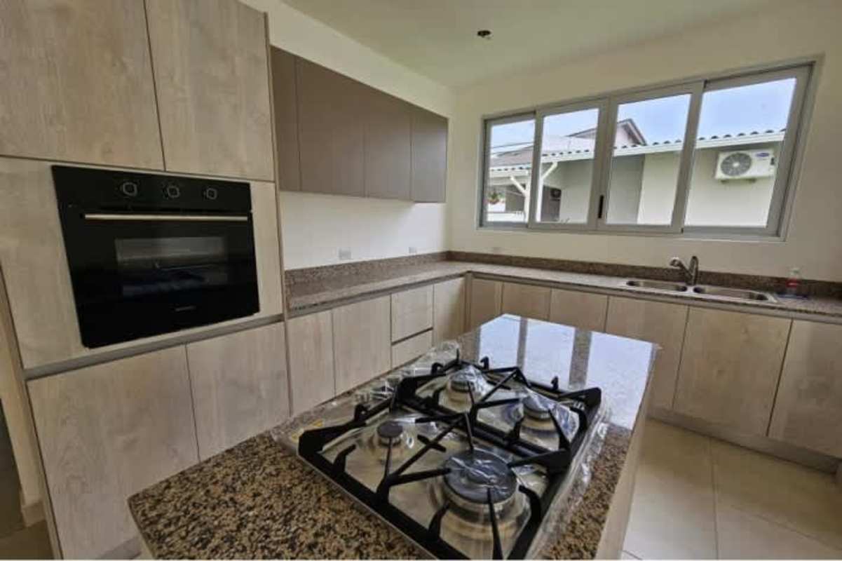 Bright bedroom with walk-in closet and balcony access in luxury Costa Sur villa Panama