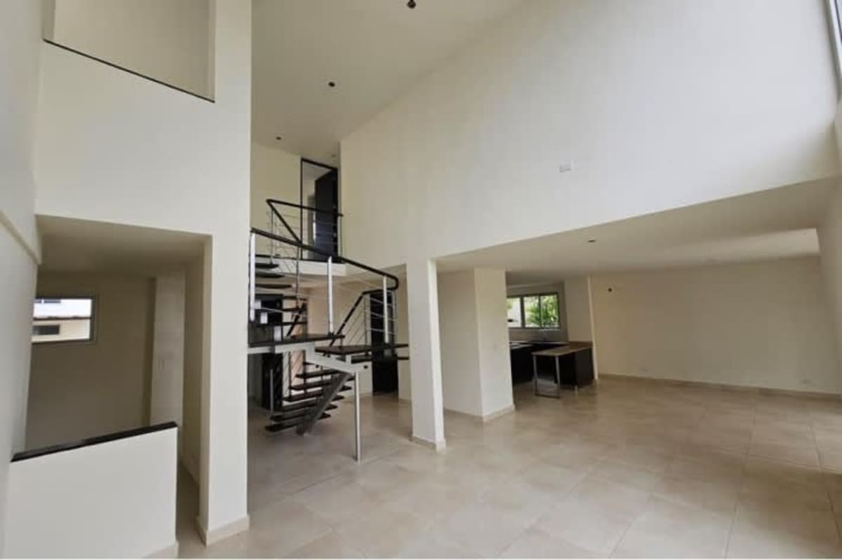 Modern kitchen with granite island, stainless appliances and large windows in Villa Sur Costa Sur house Panama