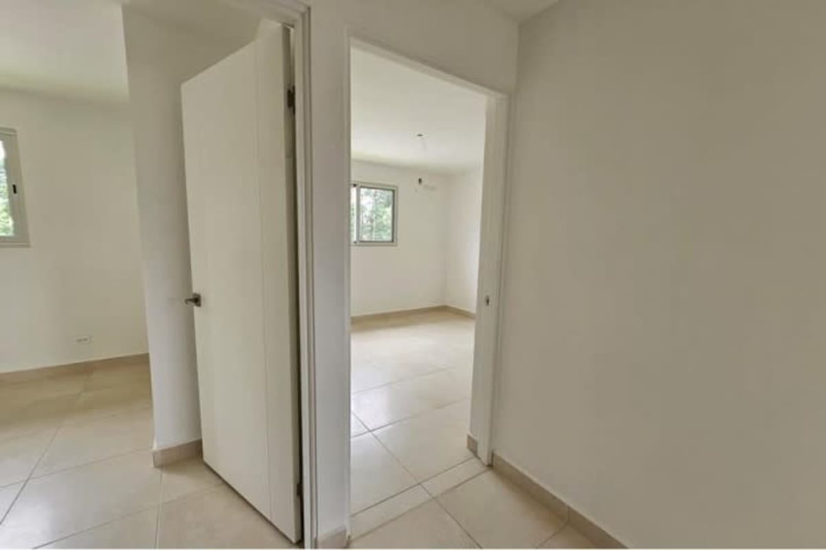 Bright hallway with light ceramic floors connecting bedrooms in townhome Costa Sur Panama
