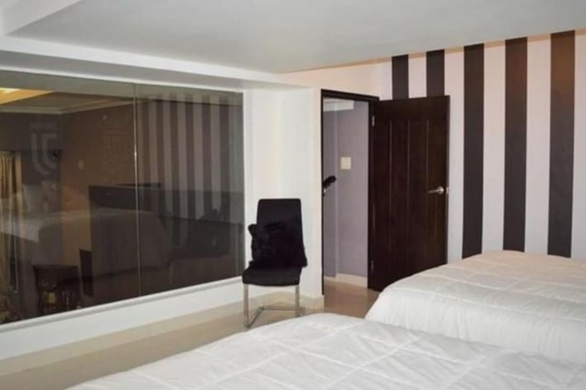 Spacious double-height bedroom with large window PH Vistanova El Cangrejo Panama City loft