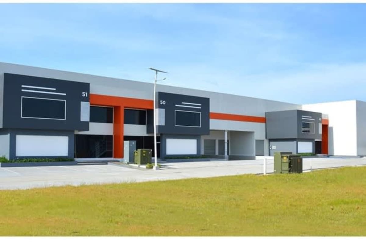 Modern warehouse unit with steel facade, loading area and green landscaping Panapark Free Zone Panama City