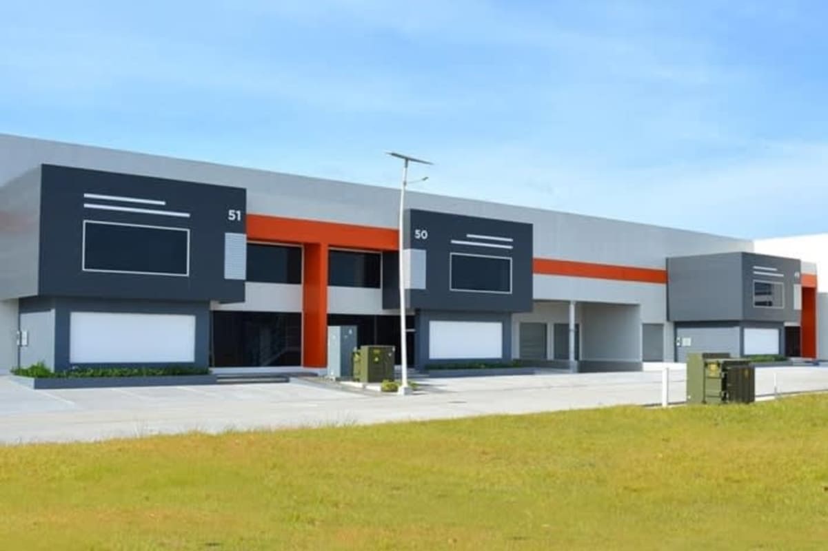 Exterior of a modern industrial warehouse building with loading docks and parking at Panapark Free Zone Panama