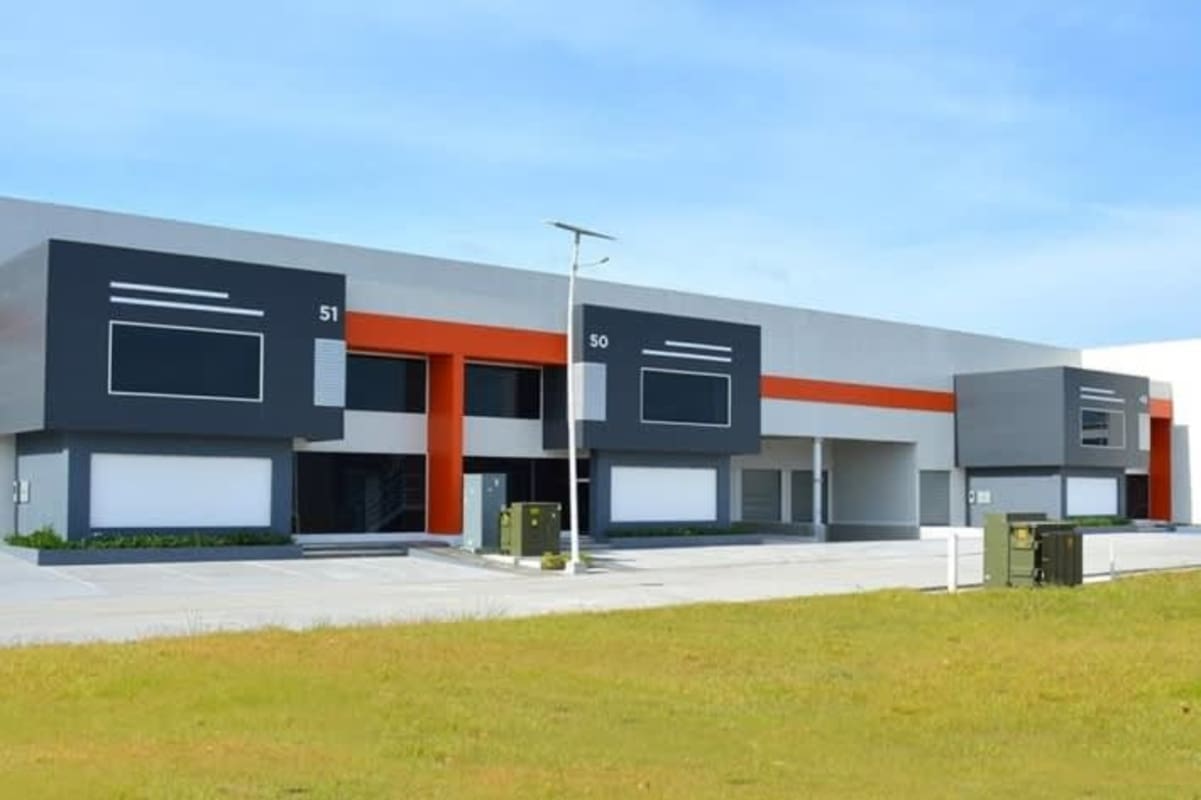 Exterior of new industrial warehouse with wide loading docks and secure entrance at Panapark Free Zone Panama