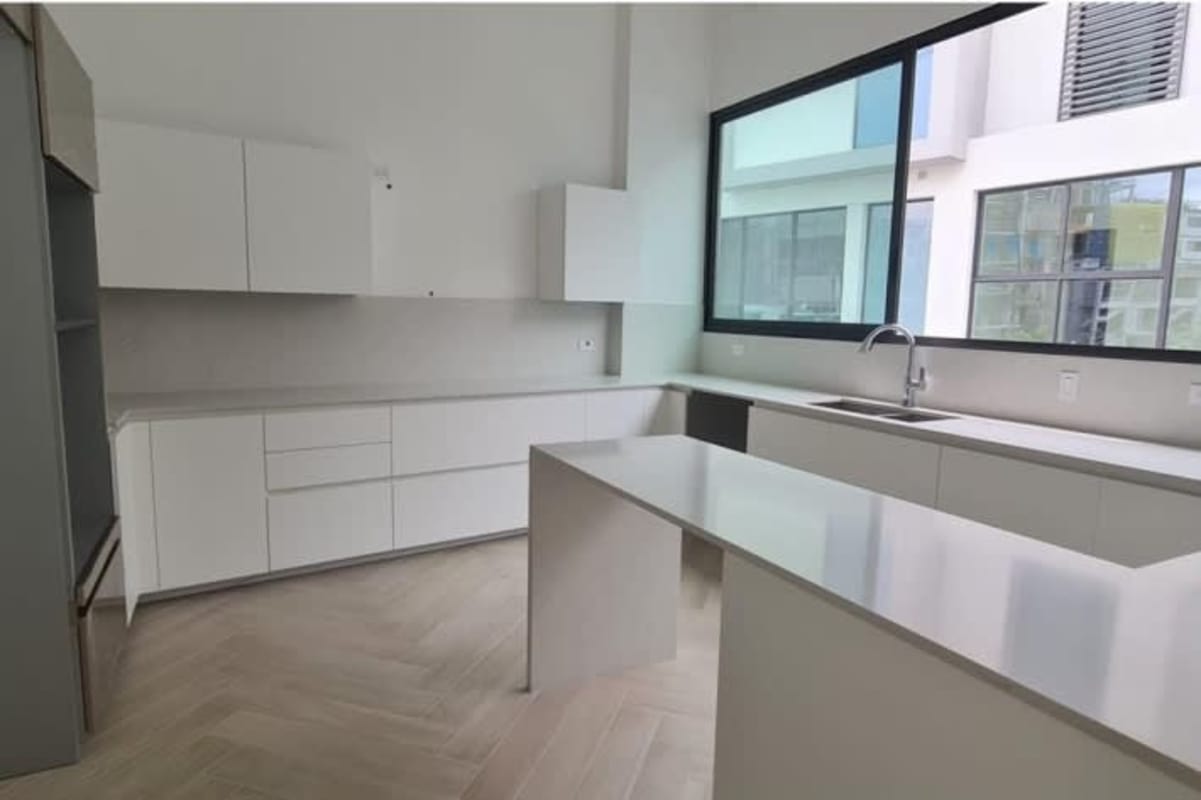 Open living room with floor-to-ceiling windows ocean city views Ocean Villas Panama