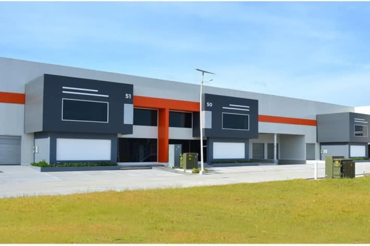 Modern industrial warehouses with accessible parking and orange accents in Panama Free Trade Zone