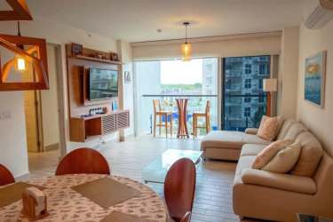 Bright oceanview living and dining room with access to balcony at PH Playa Caracol Chame Panama