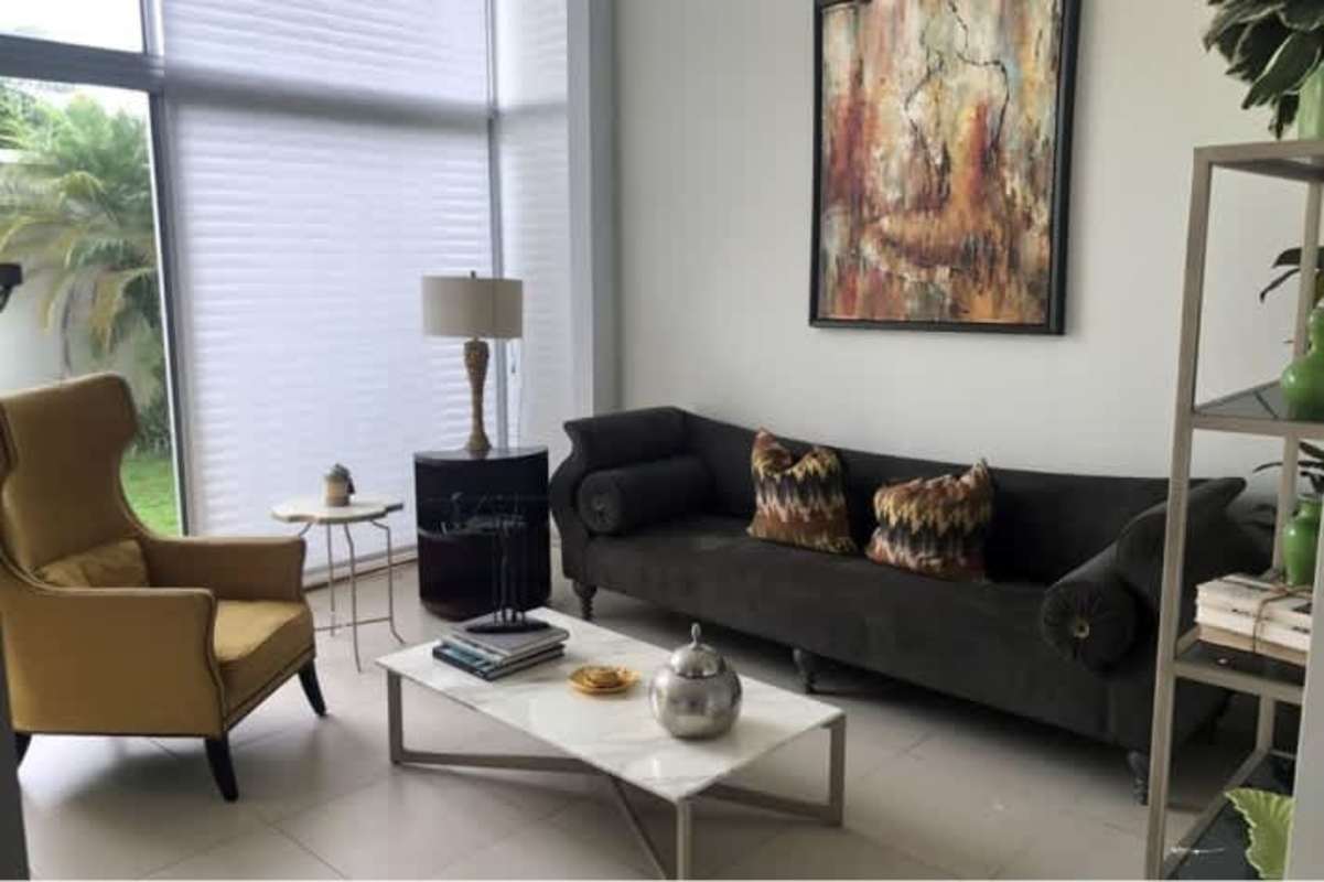 Private rooftop terrace with railings, tiled flooring and greenery view from Costa Sur Village house Panama