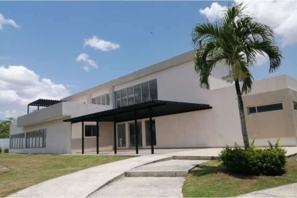 Bright open living room area with sectional sofa, dining space and kitchen view Costa Sur Village Panama