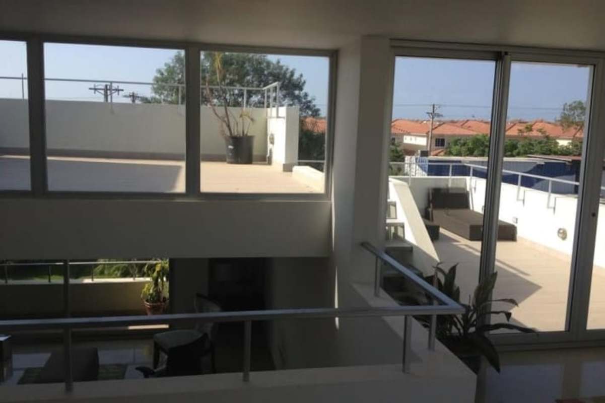 Luxury kitchen with granite countertops, island stove, dark cabinets Costa Sur Village Panama