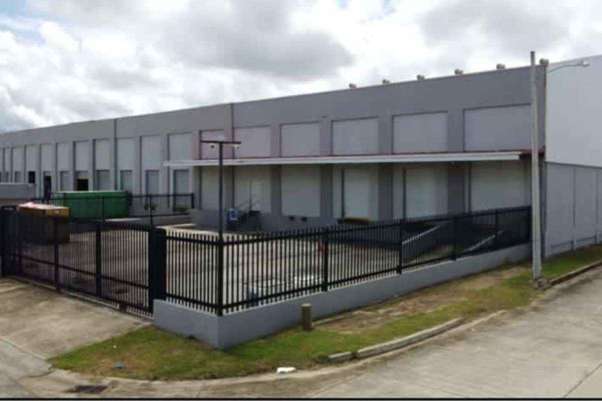 Loading docks view of large warehouse with roll-up doors in industrial park Pacora Panama