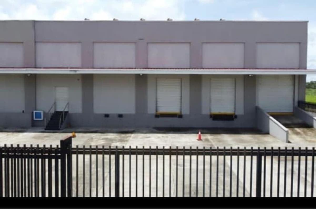 Bird's eye view of large warehouse facility with red roofs parking and loading zones Pacora Panama