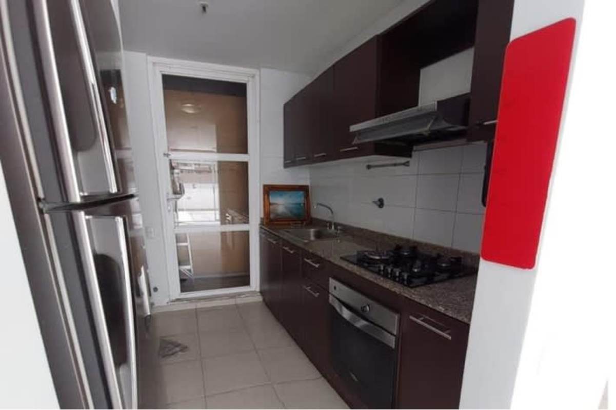 Equipped kitchen with granite counters and dark cabinetry in PH Alsacia Towers Panama