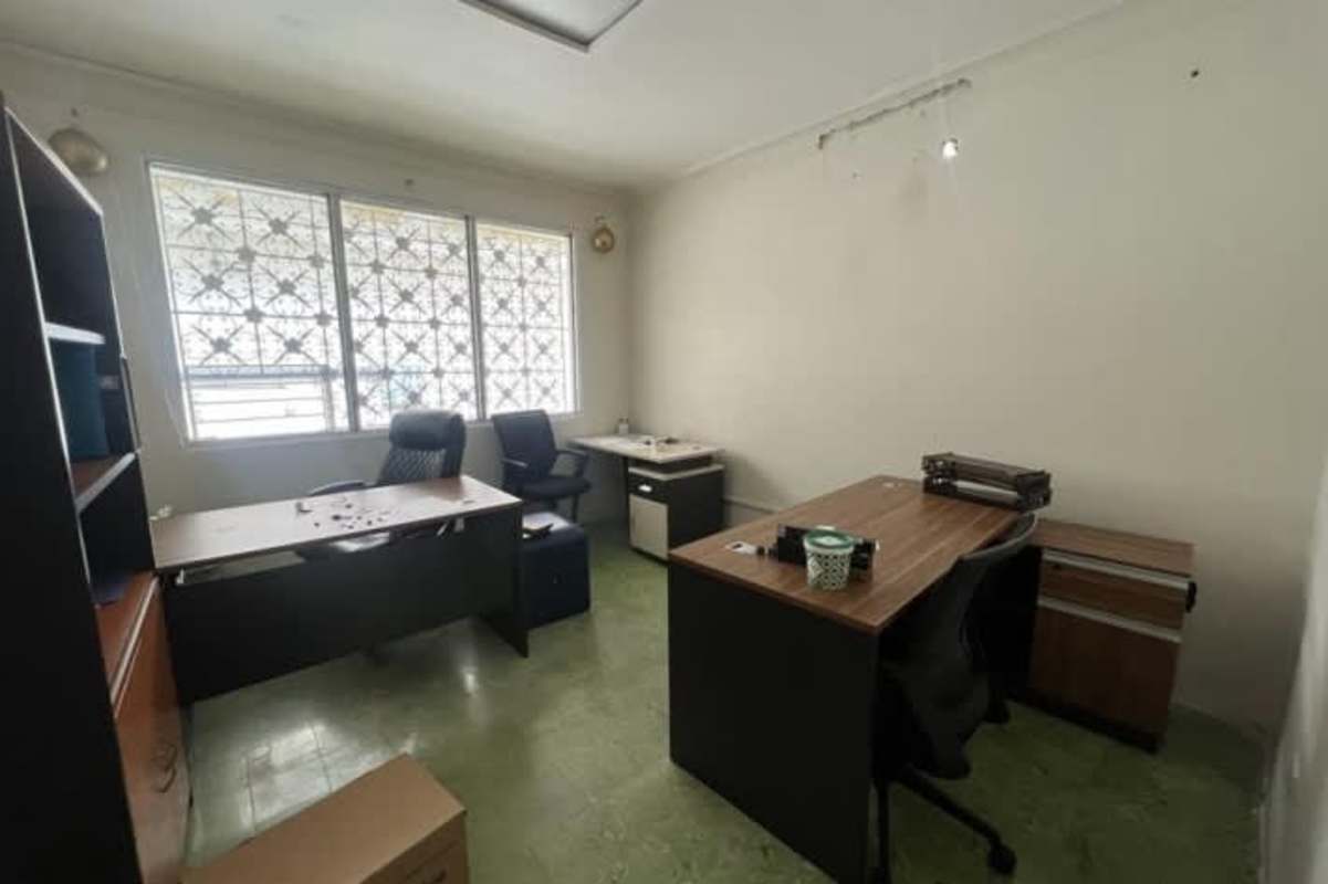 Office with desks chairs large windows decorative grills commercial property Panama City