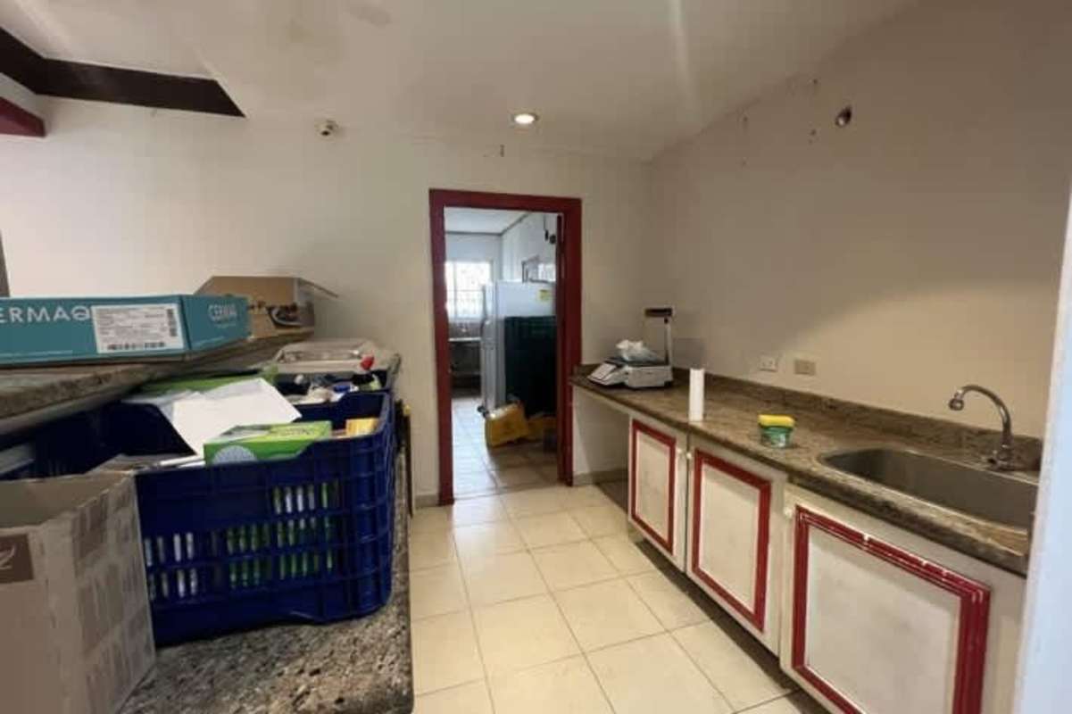 Functional prep kitchen with red-trim cabinets granite countertops commercial retail Panama