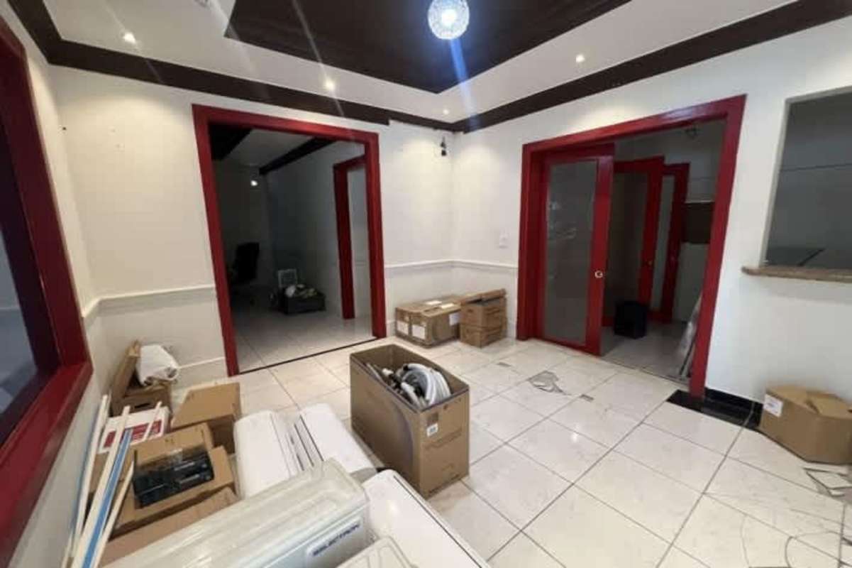 Reception lobby interior with tile floors, red accents, scattered boxes commercial property Panama