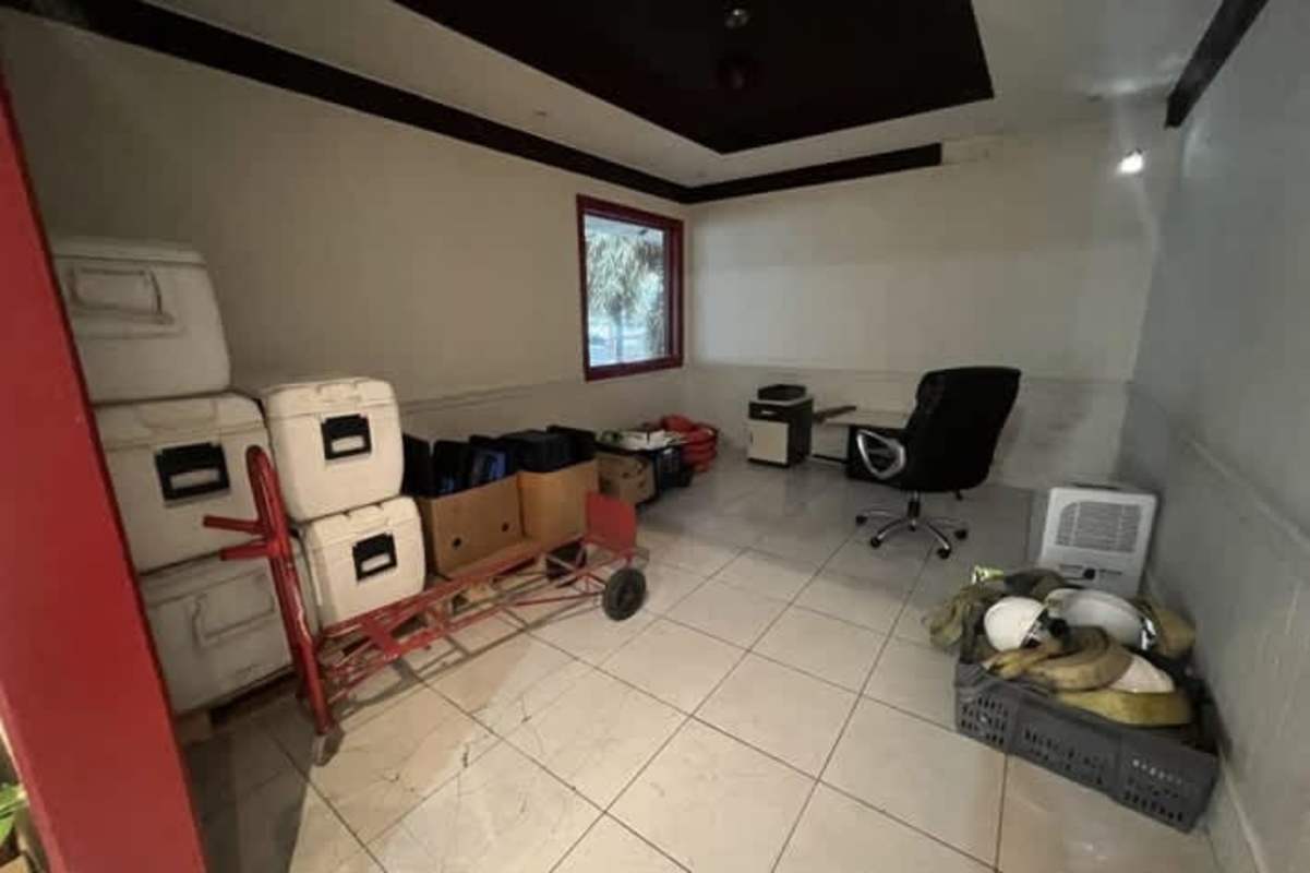 Storage office with stacked coolers supplies red accents commercial lot sale Panama City