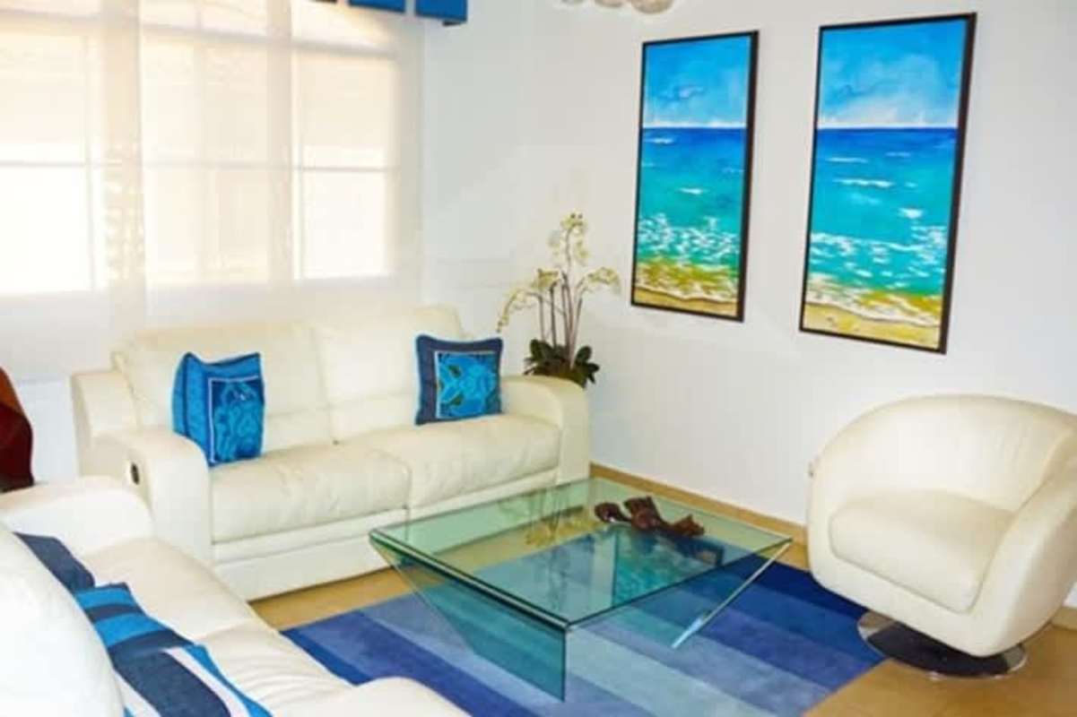 Large bright living room with windows in modern house at El Doral gated community Panama