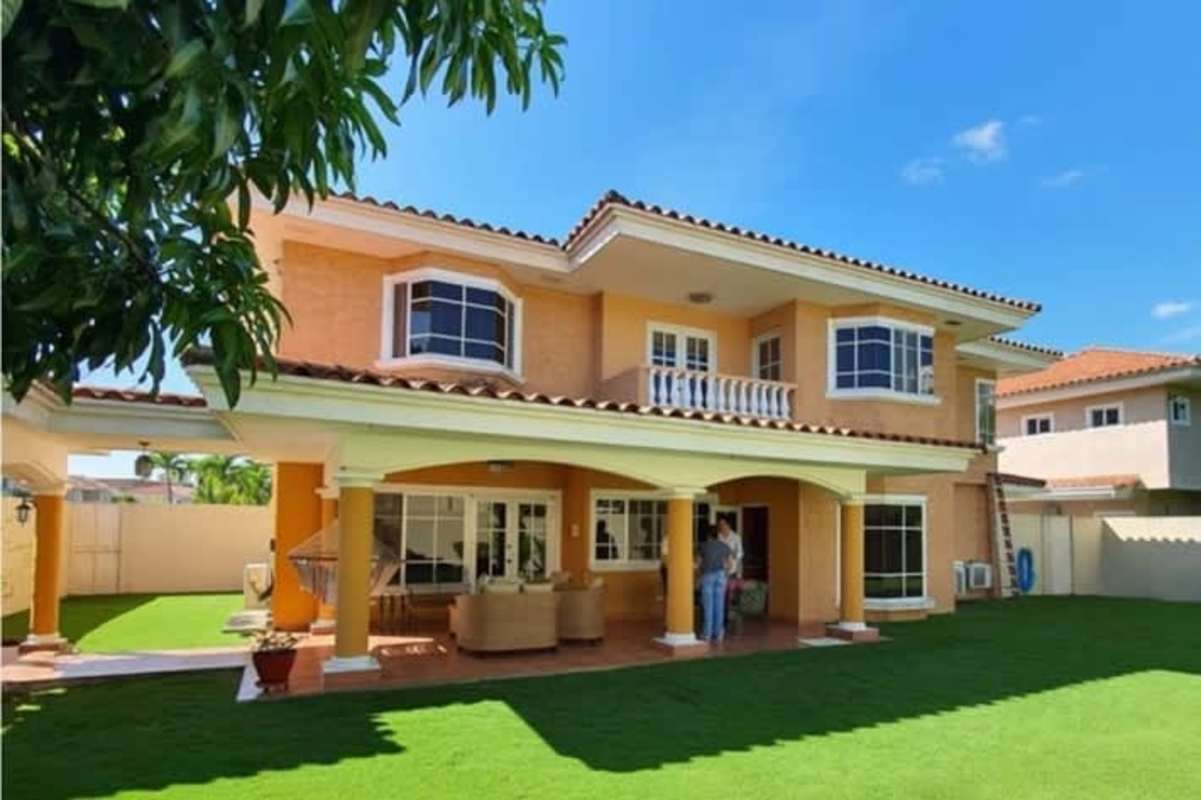 Contemporary living room with green sofa, large windows, decorative accents in Palmeras del Este Costa del Este Panama