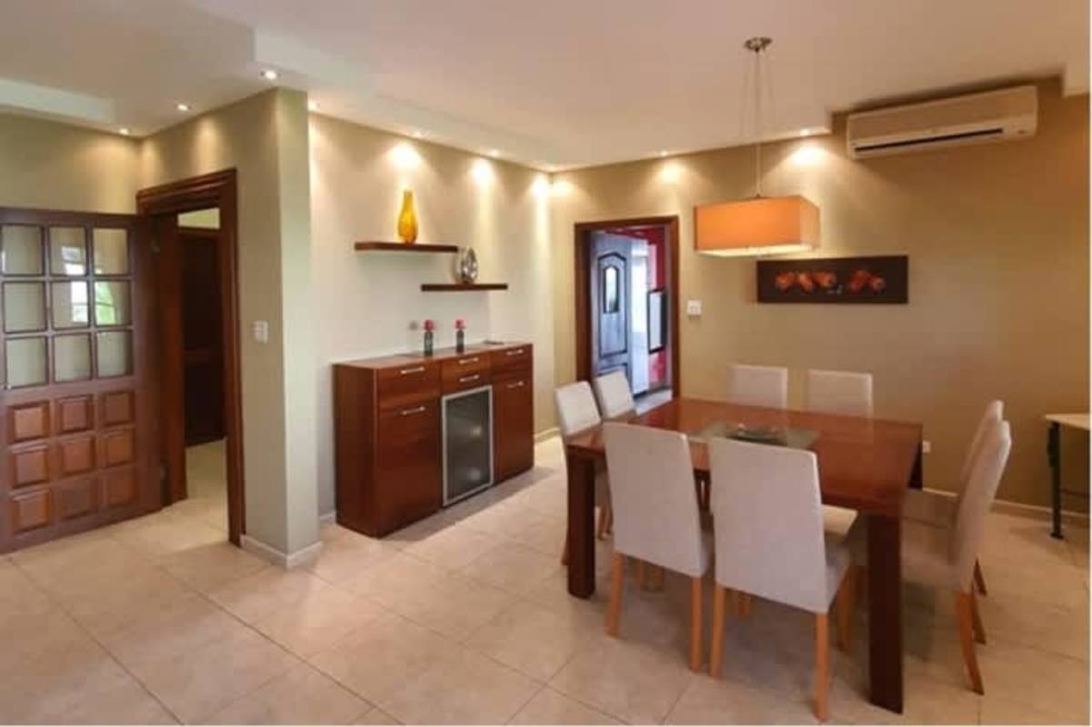 Contemporary kitchen with red cabinetry, stainless appliances granite counters Palmeras del Este Panama