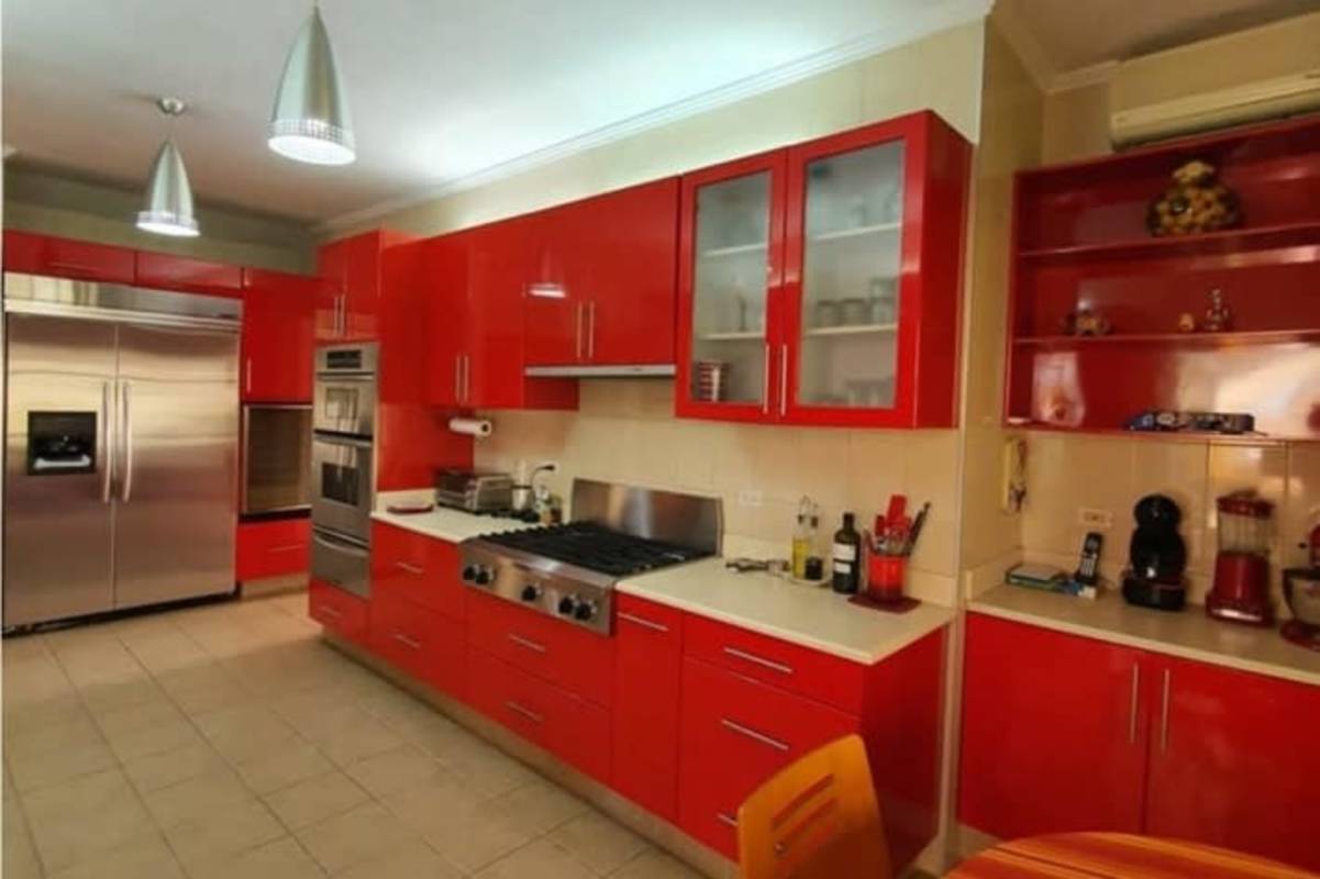 Dining room with wood table, upholstered chairs and pendant lighting in Palmeras del Este Costa del Este Panama