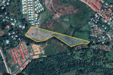 Large open countryside plot with scattered trees and adjacent residences Veraguas Panama