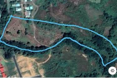 Aerial neighborhood near land for sale with homes red roofs and green surroundings Veraguas Panama