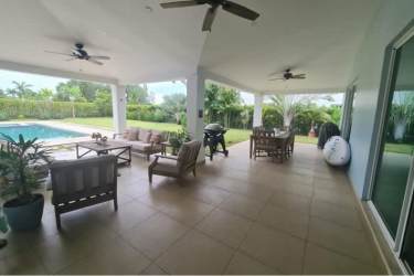 Elegant open concept kitchen with breakfast island granite counters at Bijao Beach villa Panama