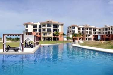 Luxury beachfront condo with resort pool cabanas and gardens at Vista Mar San Carlos Panama