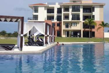 Beachfront condo complex with oceanview pool and palm gardens at Casa Real Vista Mar Panama