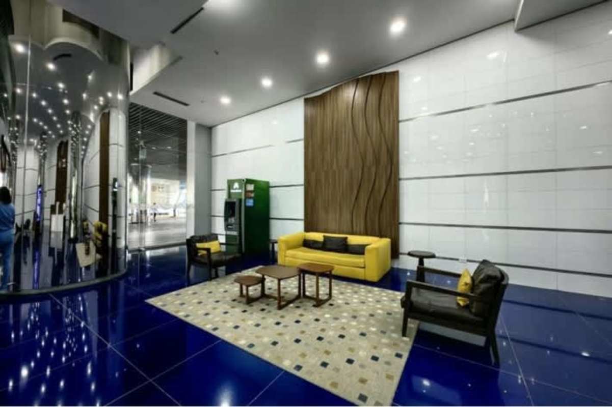 Elegant office lobby with yellow sofa and ATM in PH Oceania Business Plaza Panama