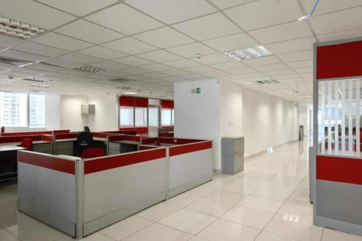 Large corporate office with cubicles, tiled floors, and natural lighting at PH Oceania Business Plaza