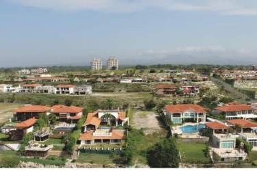 Aerial view of oceanfront Mediterranean villas with pools at Vista Mar Golf & Beach Resort Panama