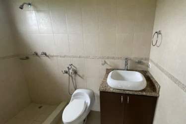 Spacious living area with tiles, terrace access, ceiling fan in coastal Panama villa for sale