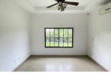 Living room with large arched window, ceiling fan ready, ceramic flooring in Hacienda Pacífica San Carlos Panama