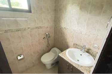 Residents clubhouse with swimming pool surrounded by palm trees Hacienda Pacífica San Carlos Panama