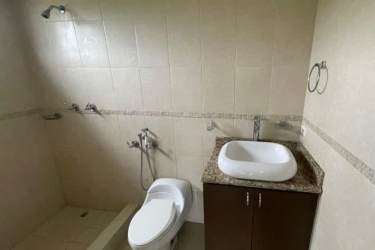 Contemporary bathroom with walk-in shower and granite sink counter in Hacienda Pacifica house