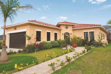 Spanish revival house with red tile roof and garage Hacienda Pacífica Panama