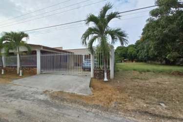 Bright living room with large sectional sofa ceiling fan tile floor in house for sale Nueva Gorgona Panama