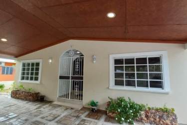 Spacious kitchen with granite countertop center island wooden cabinets appliances in Nueva Gorgona Panama home