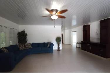 Open living space with tile floors sectional sofa ceiling fan Nueva Gorgona Panama house for sale