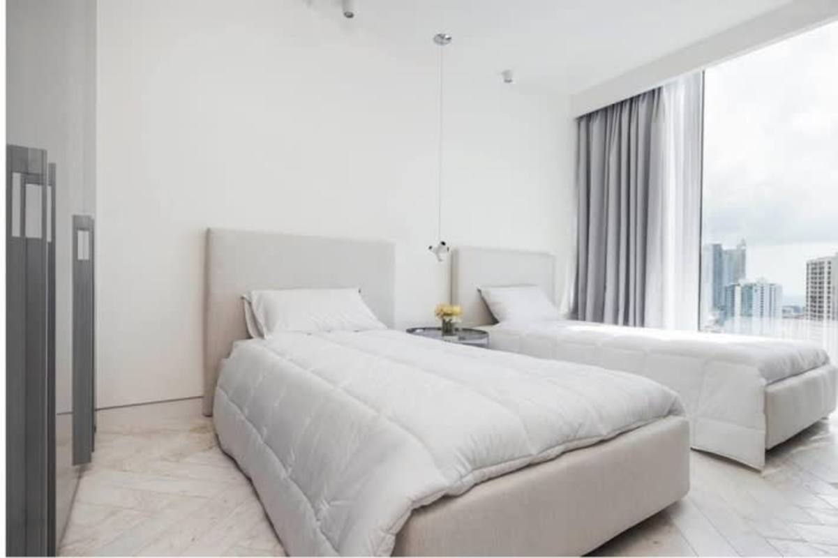 Bedroom with panoramic windows ocean and skyline views Wanders Yoo Marbella Panama