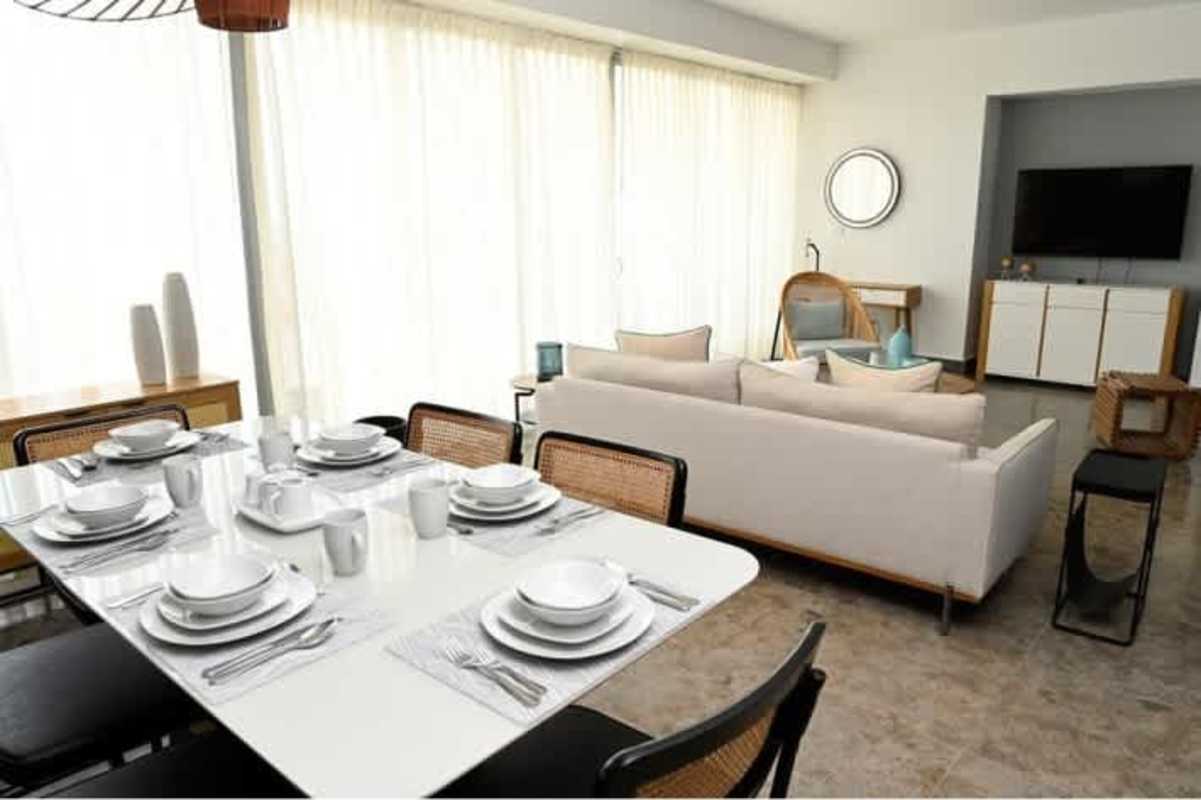 Spacious open concept living dining room with large windows, skyline view at Yoo Panama