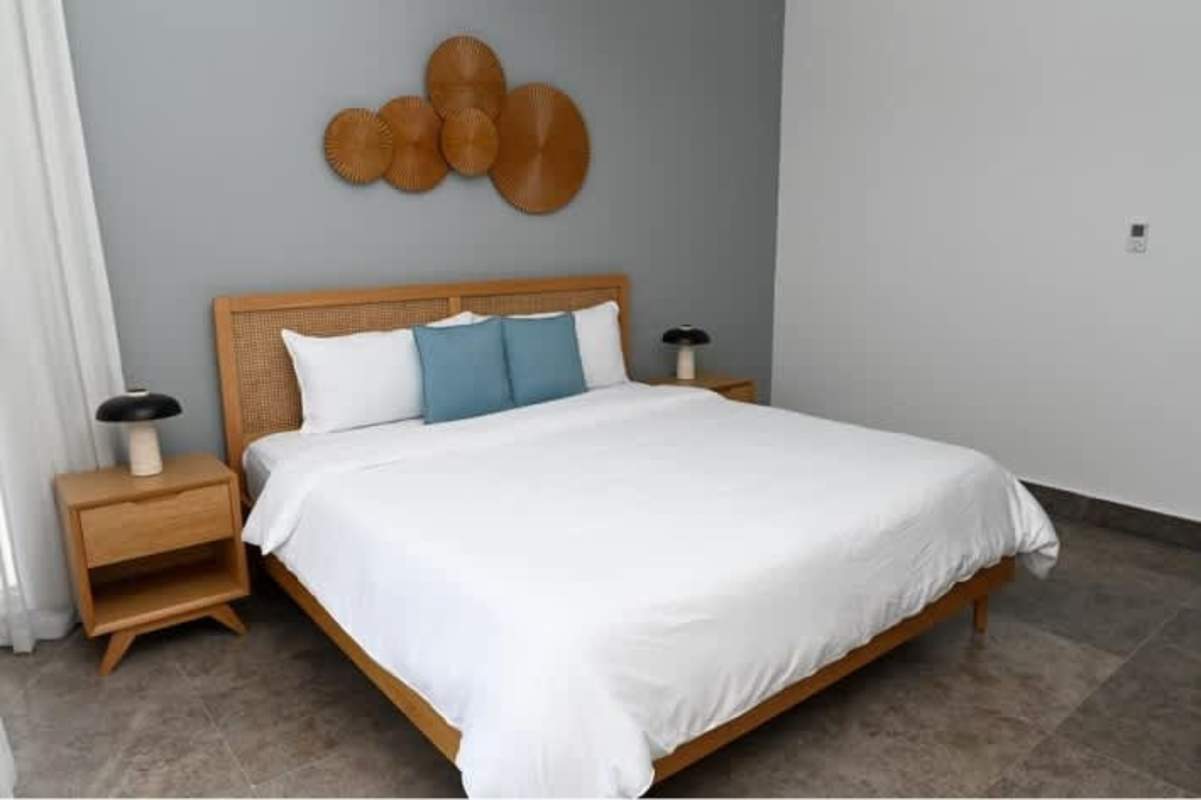 Minimalist master bedroom with wood furniture sea and skyline views Yoo Panama Avenida Balboa