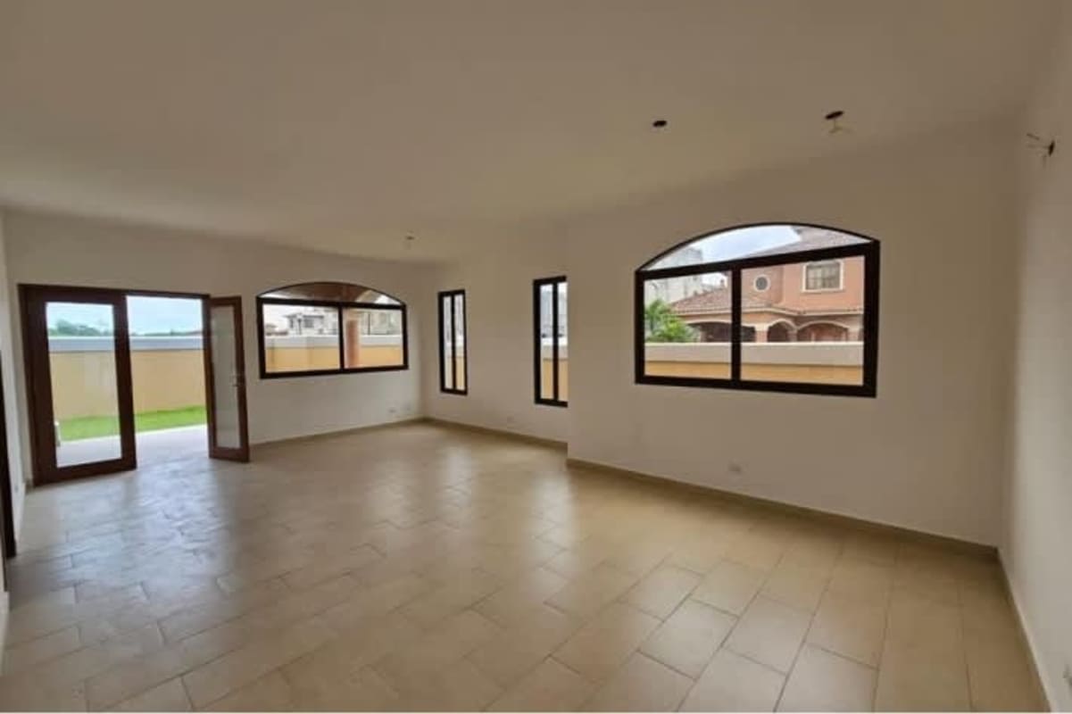 Living room with large arched windows tiled flooring in luxury house El Doral Costa Sur Panama