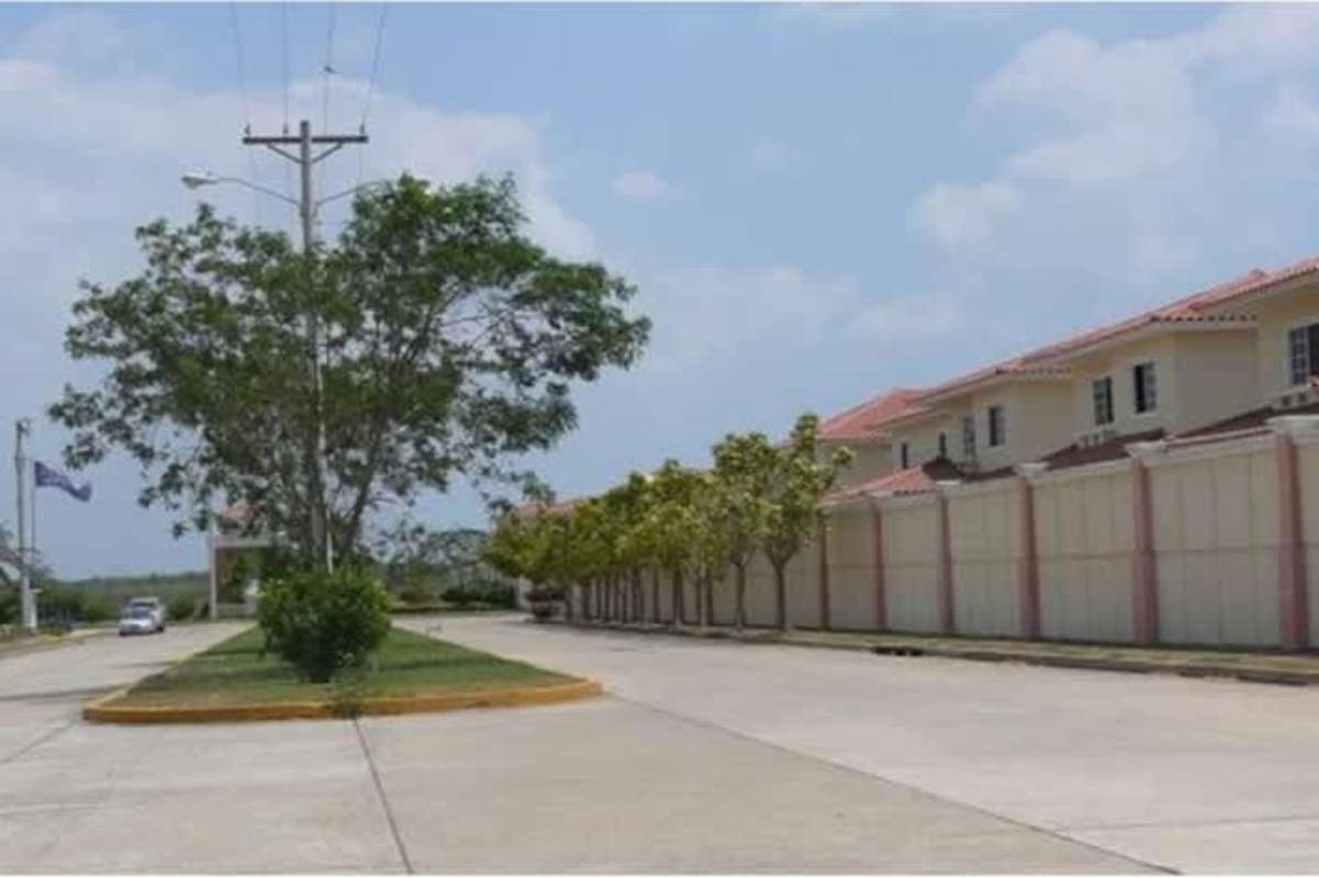Street view of suburban housing adjacent to commercial development land in Don Bosco Panama City