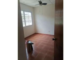 Bedroom with ceiling fan, large window, garden view in house Chitré Panama