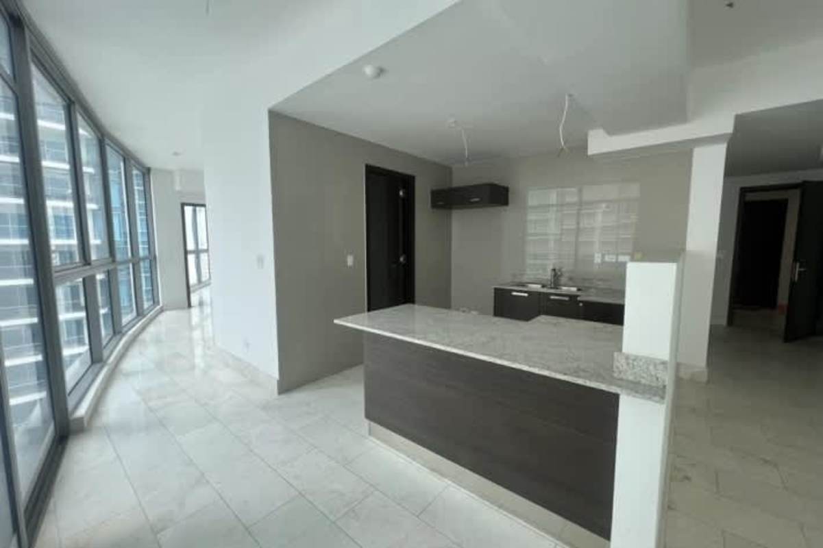 Living and dining area with floor-to-ceiling sliding doors leading to balcony in PH Grand Tower Punta Pacifica Panama City