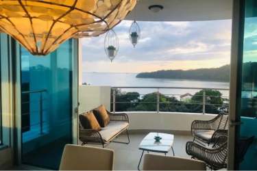 Modern balcony with wicker seating and panoramic ocean views at Casa Bonita Playa Bonita Panama