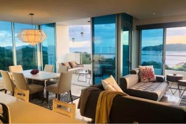 Modern dining space with large windows offering Pacific ocean views in Casa Bonita Playa Bonita Panama